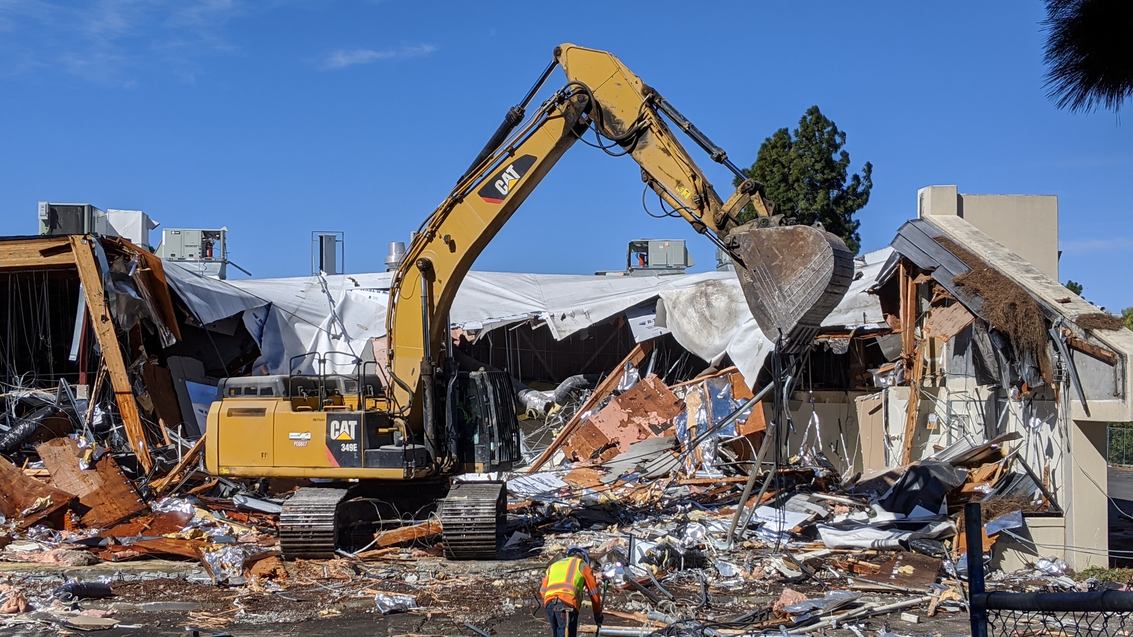 Excavator working at a real demolition site
